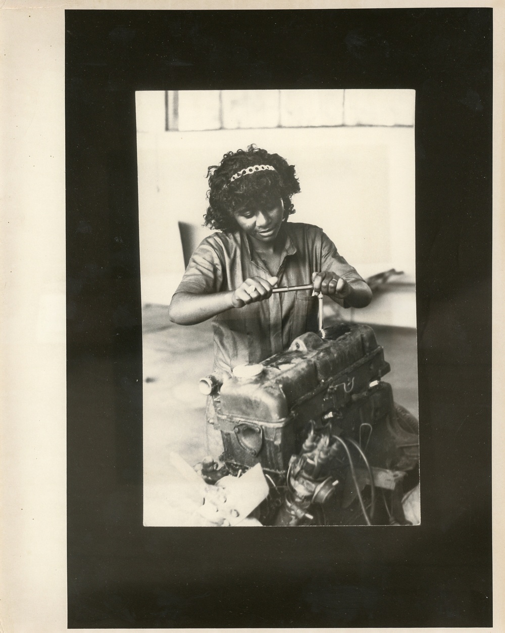 Woman working on an engine