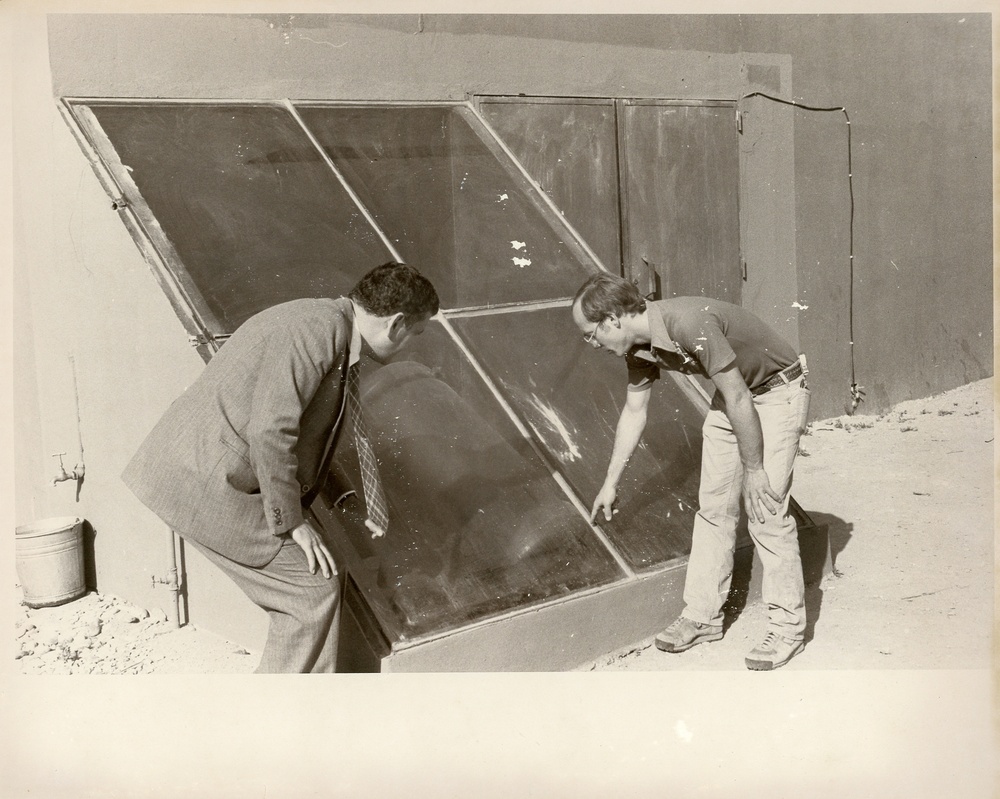 Men observing glass panes