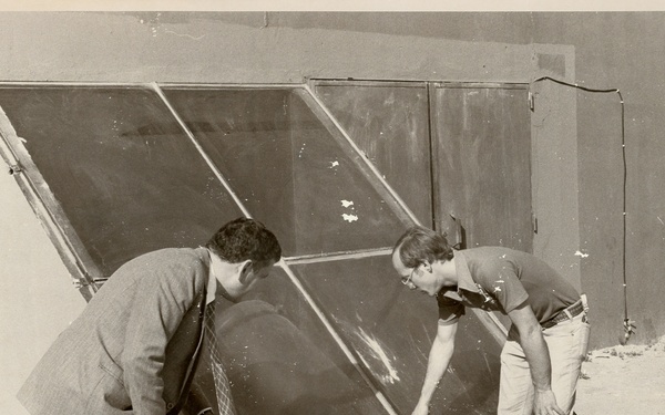 Men observing glass panes