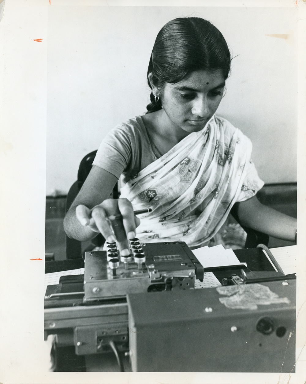 Woman working an IBM machine