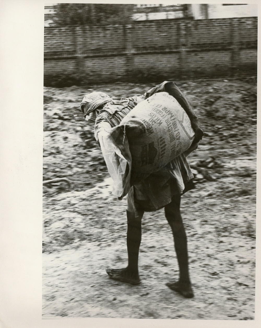 Boy/man carrying a sack