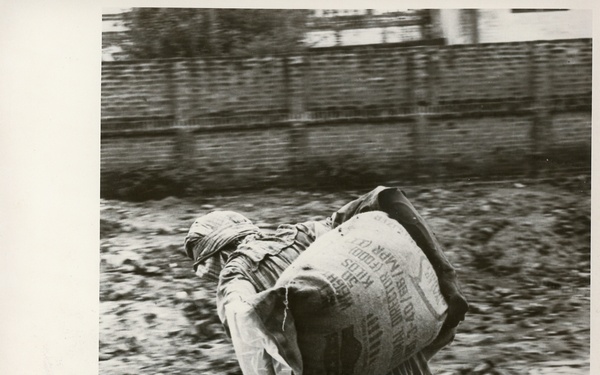 Boy/man carrying a sack