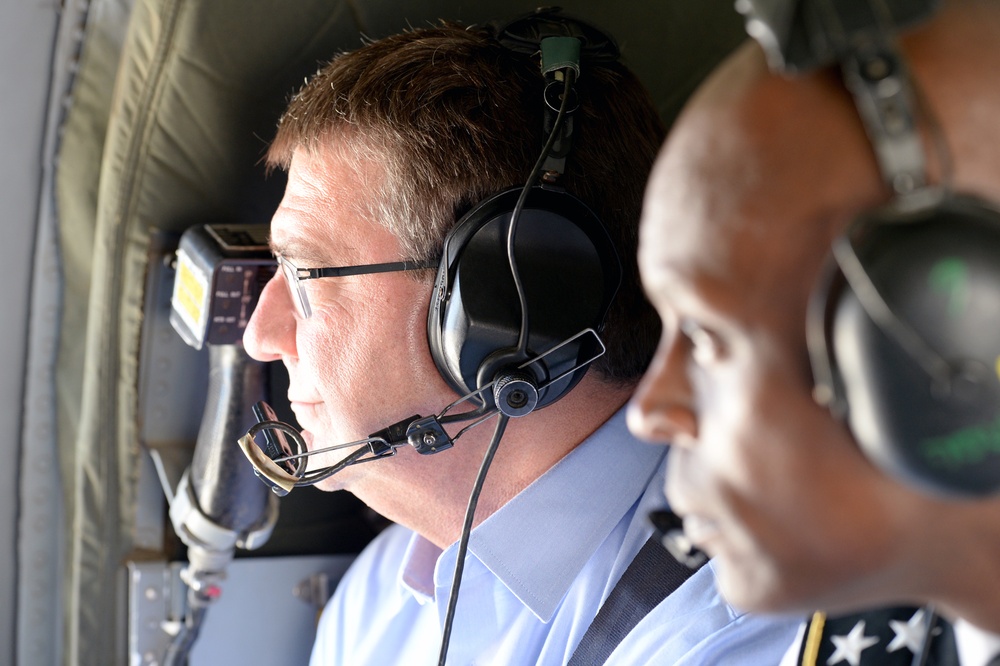 Secretary and Lt. Gen. Lewis look out window