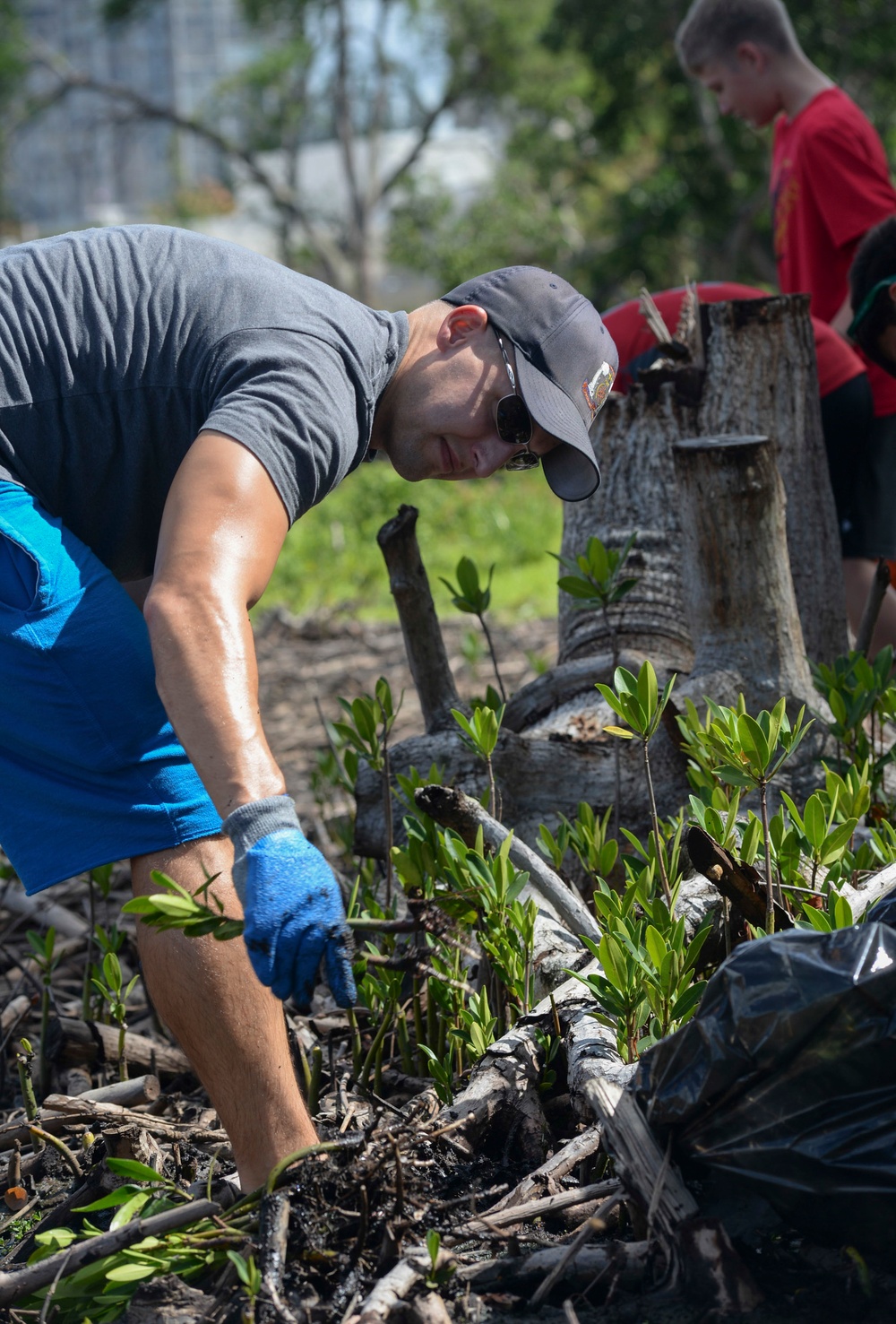 Sailors assist in a cleanup at the ancient fishpond, Loko Pa’aiau, on Oahu