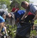 Sailors assist in a cleanup at the ancient fishpond, Loko Pa’aiau, on Oahu