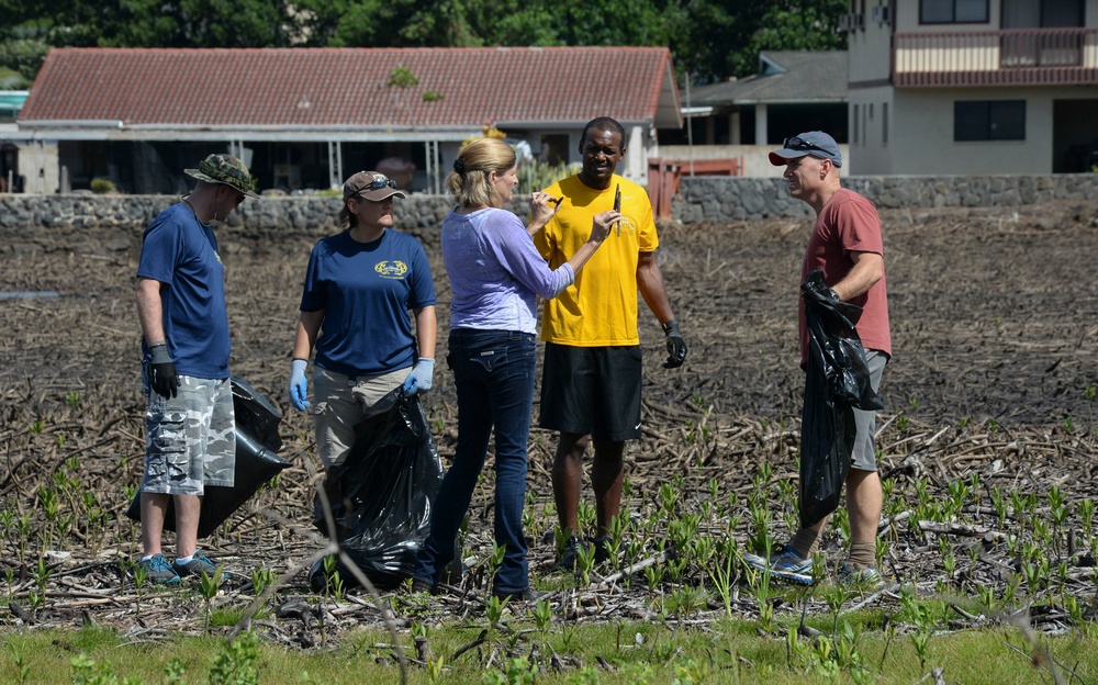 Sailors assist in a cleanup at the ancient fishpond, Loko Pa’aiau, on Oahu