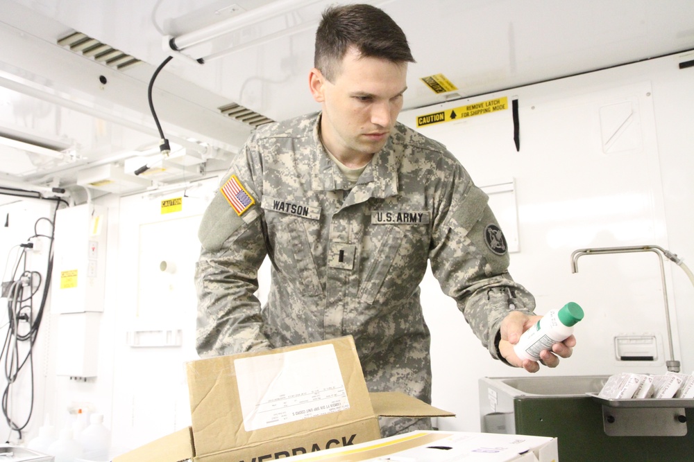 Service member inspects supplies prior to performing surgery at IRT in Norwich, NY