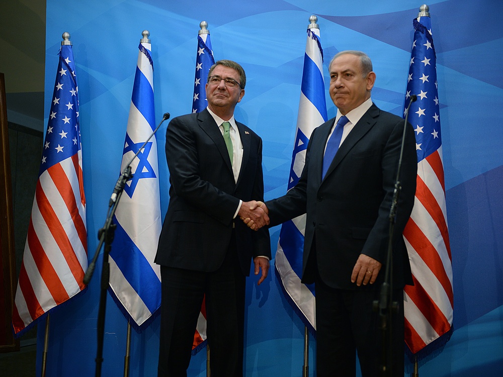 Secretary of defense and Israel's PM shake hands