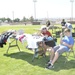 Julia and Ryan Kretschmer, wife and son of 1st Sgt. Kretschmer, the base first sergeant aboard Marine Corps Logistics Base Barstow, Calif., sell books, clothing and household items at the Multi-Family Yard Sale held on Sorenson Field aboard the base, July