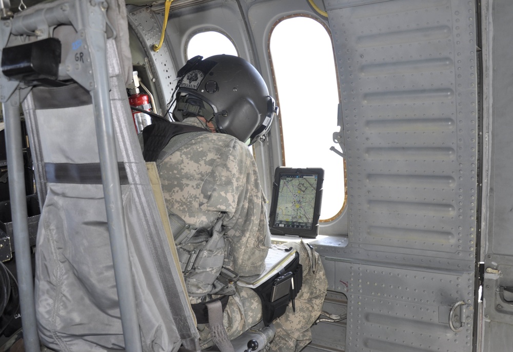 Capt. Adam Kennedy, commander of Alpha Company, 2916th Aviation Battalion with U.S. Army National Training Center Fort Irwin, stationed at Barstow-Daggett Airport, keeps a watchful eye on the maps he downloaded to his iPad and monitors the progress