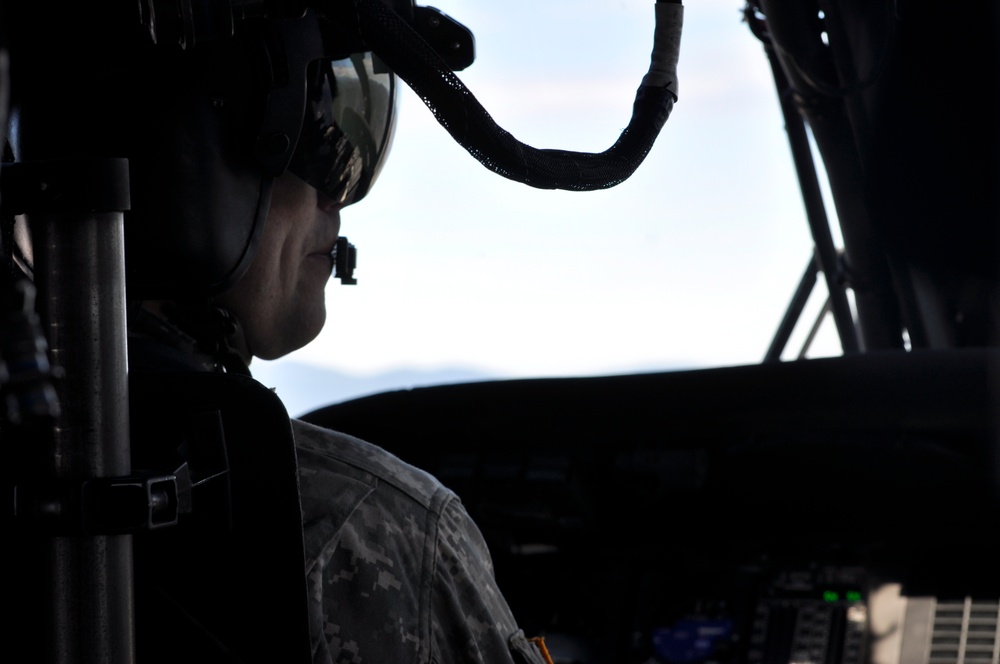Chief Warrant Officer 3 Ryan Skopek, helicopter pilot with A Company, 2916th Aviation Btn, U.S. Army NTC, Fort Irwin, stationed at Barstow-Daggett Airport keeps an eye on gauges in a Black Hawk aircraft