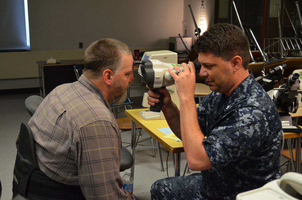Service member conducts eye exam during IRT in Norwich, NY