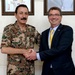 Secretary of defense shakes hands with Gen. Mash'al Mohammad al Zaben