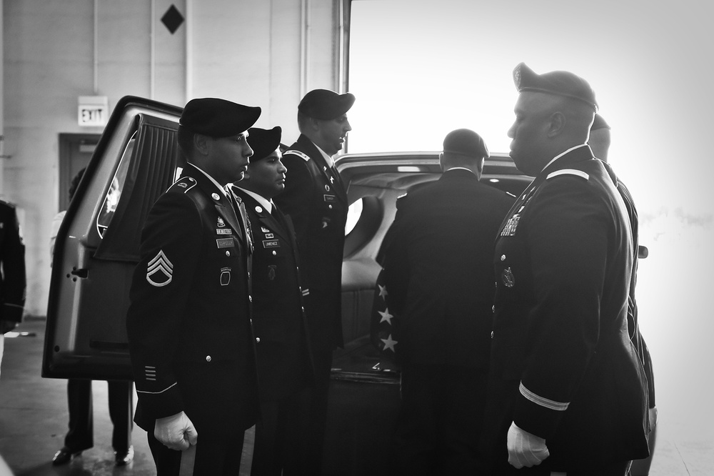 Army Reserve soldiers conduct a plane-side honor for fallen soldier