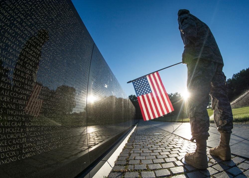 Soldier at the Vietnam Memorial wall