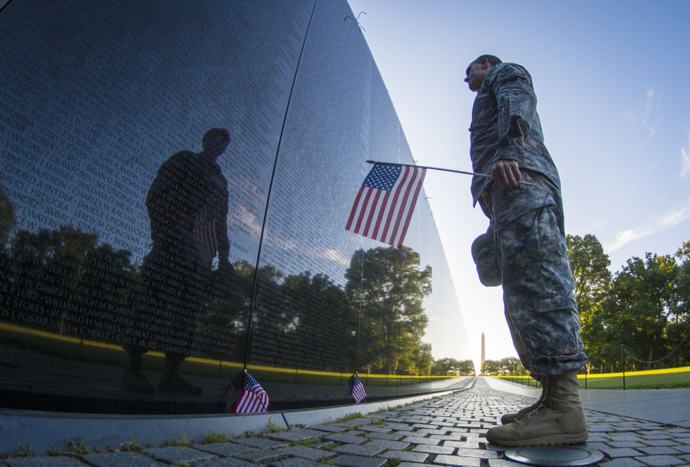 Soldier reflects at Vietnam Memorial wall