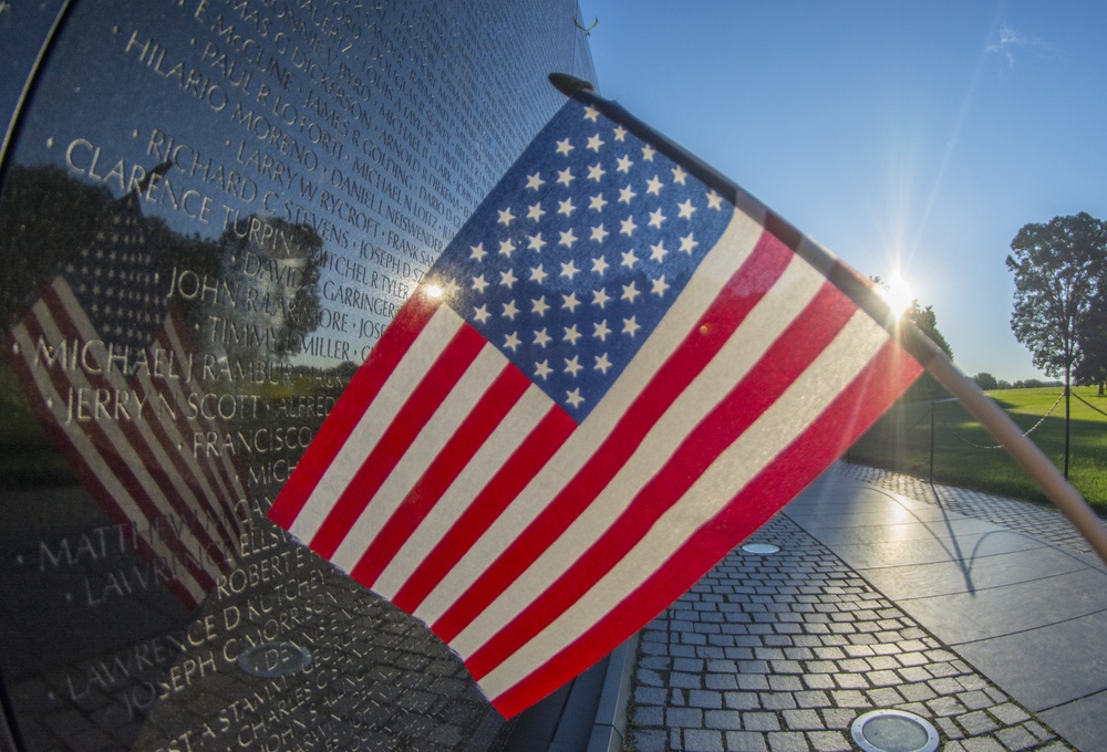 American flag at Vietnam Memorial wall