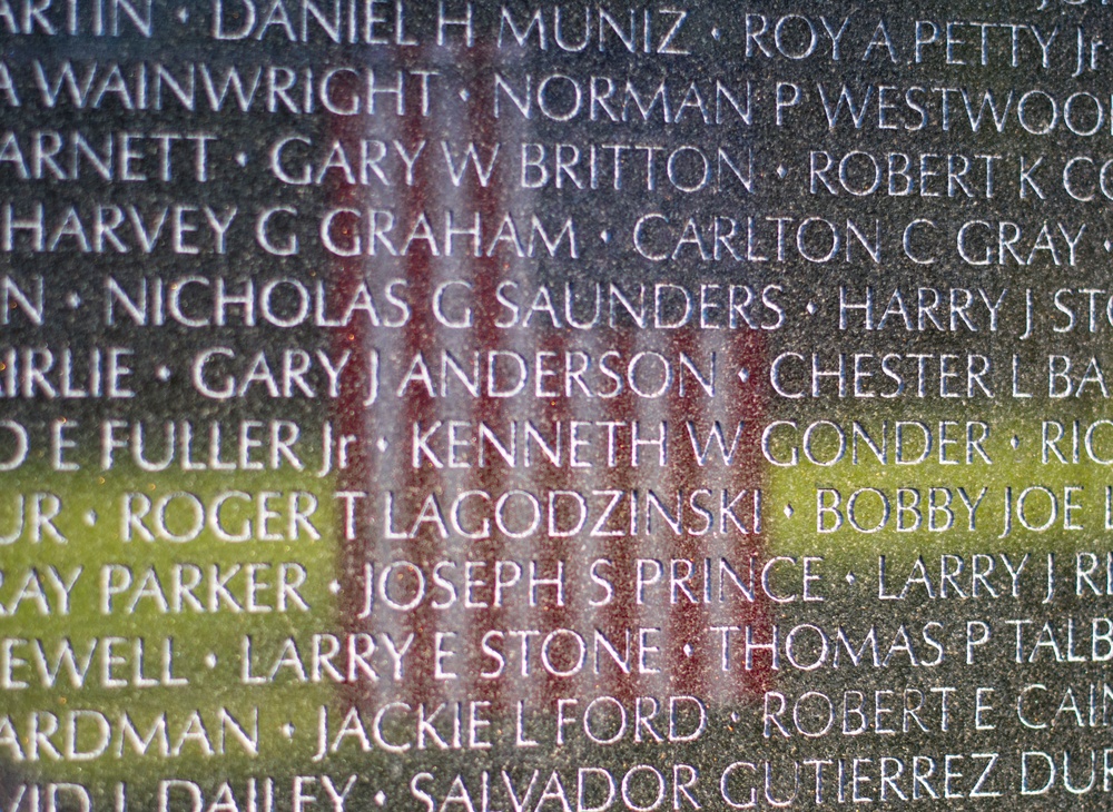 American flag reflected in the Vietnam Veterans Memorial wall