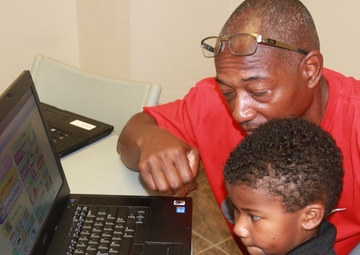 1st Sustainment Command (Theater) donates computers to local school