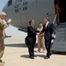 Secretary of defense is greeted by Lt. Gen. Terry and US Ambassador Stuart Jones