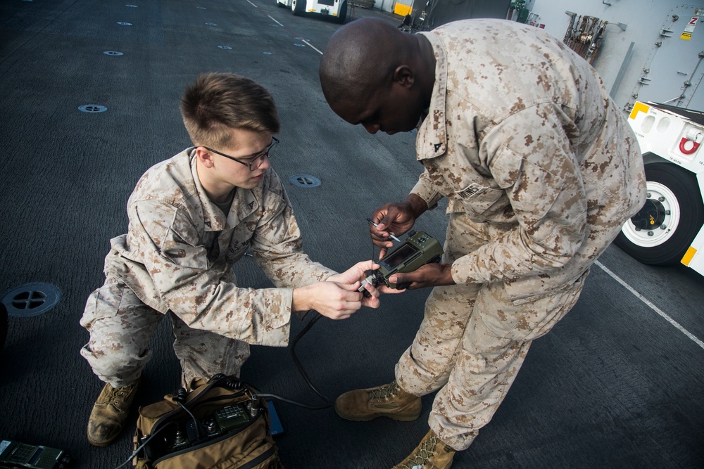 U.S. Marines perform radio checks at sea