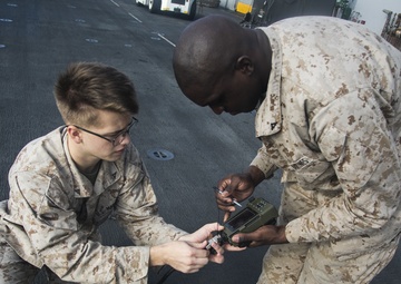 U.S. Marines perform radio checks at sea