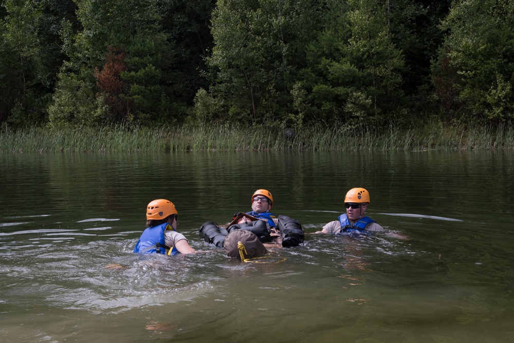 Soliders hoist floating litters