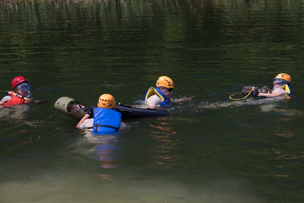Soldiers hoist floating litters