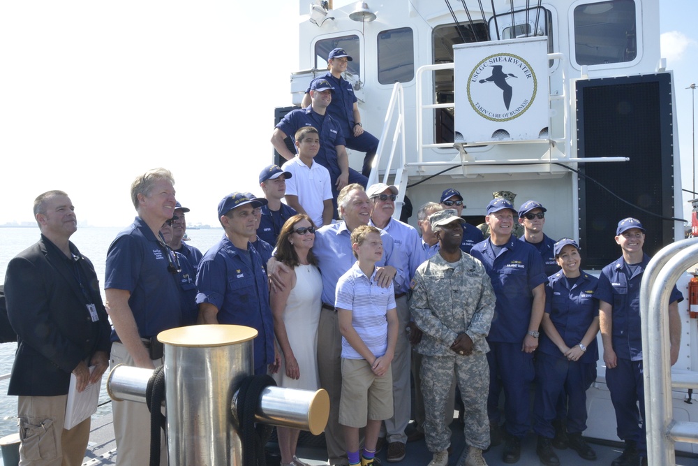 Gov. Terry McAuliffe stands with Rear Adm. Stephen P. Metruck at Coast Guard Base Portsmouth