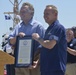 Rear Adm. Stephen P. Metruck and Gov. Terry McAuliffe present certificate of recognition