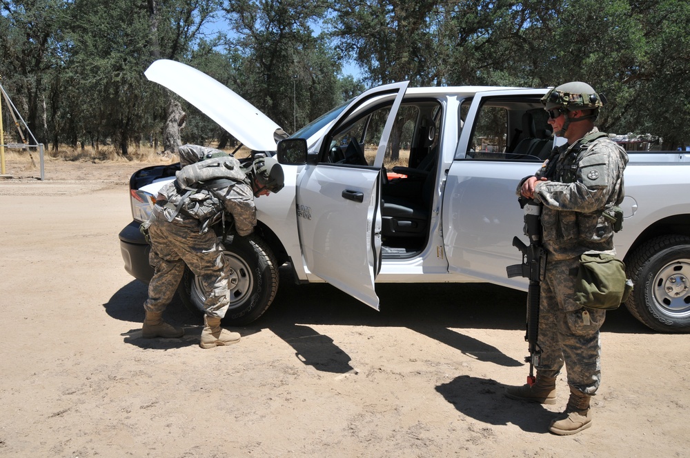 Army Reserve Soldiers with the 221st Ordnance Company conduct a vehicle search at a field checkpoint