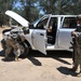 Army Reserve Soldiers with the 221st Ordnance Company conduct a vehicle search at a field checkpoint