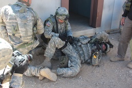 Kington administers a tourniquet