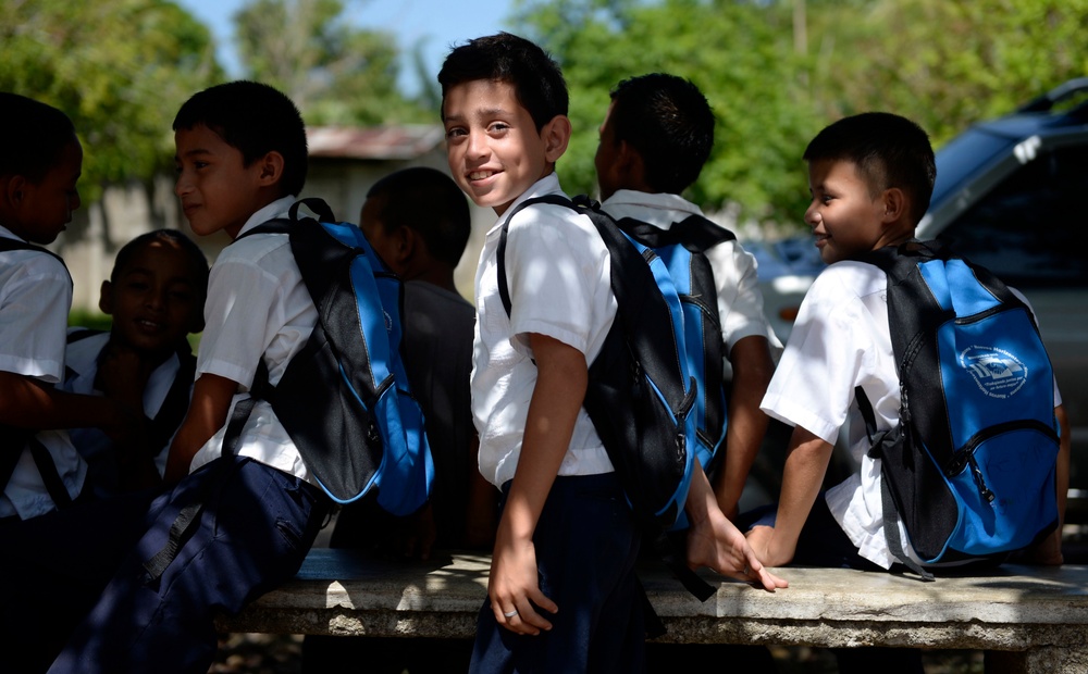 Local Honduran children show off their new backpacks
