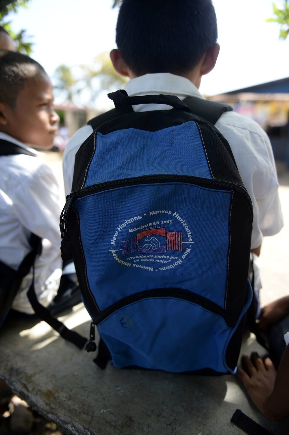 Local Honduran children show off their new backpacks