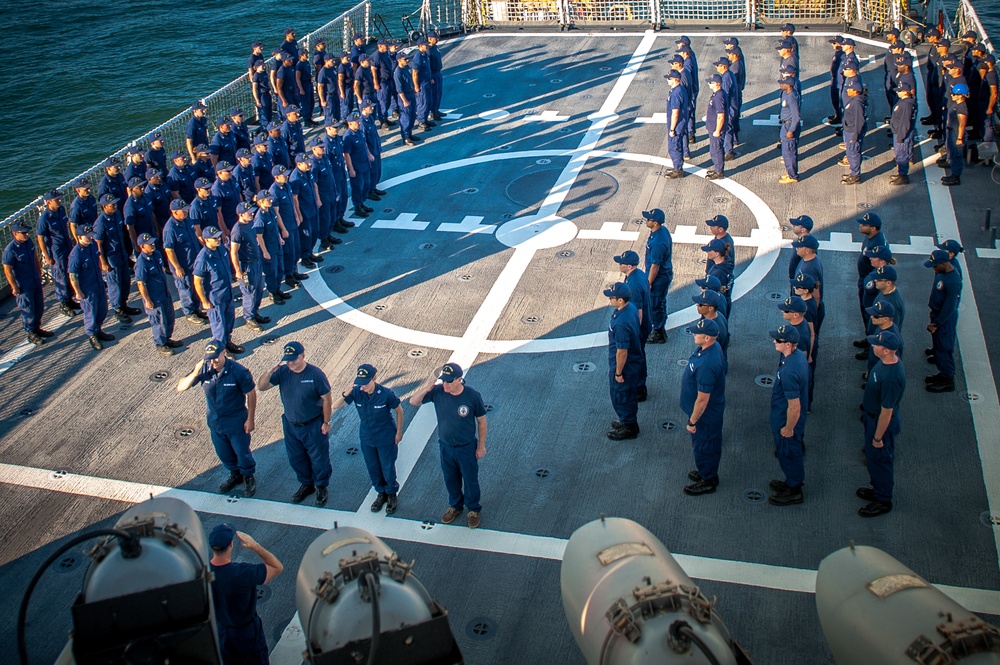 Crew members of the US Coast Guard cutter James stand at attention