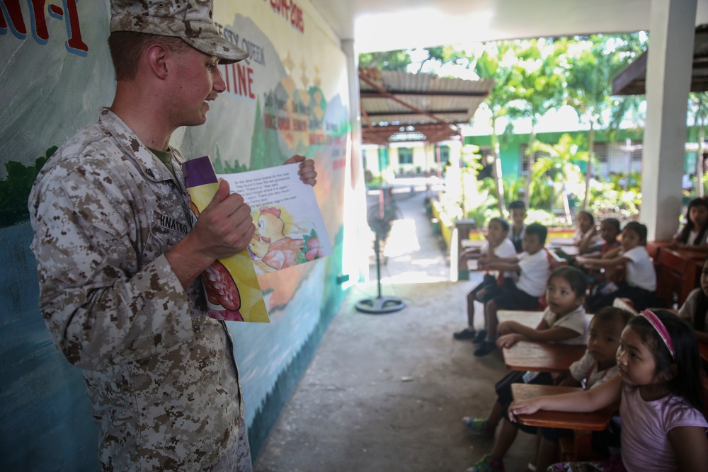 Service members read to Philippine elementary students