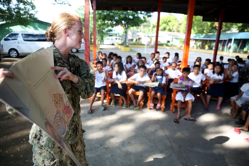 Service members read to Philippine elementary students