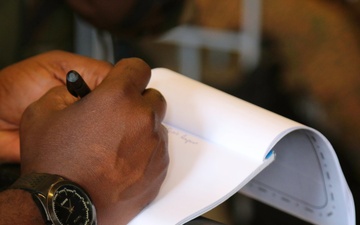 A participant of Western Accord 2015 exercise take notes during a class on information gathering