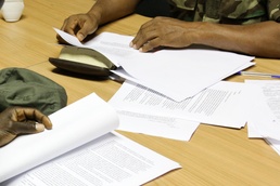 Staff members participating in Western Accord 2015 discuss operations during the command post exercise