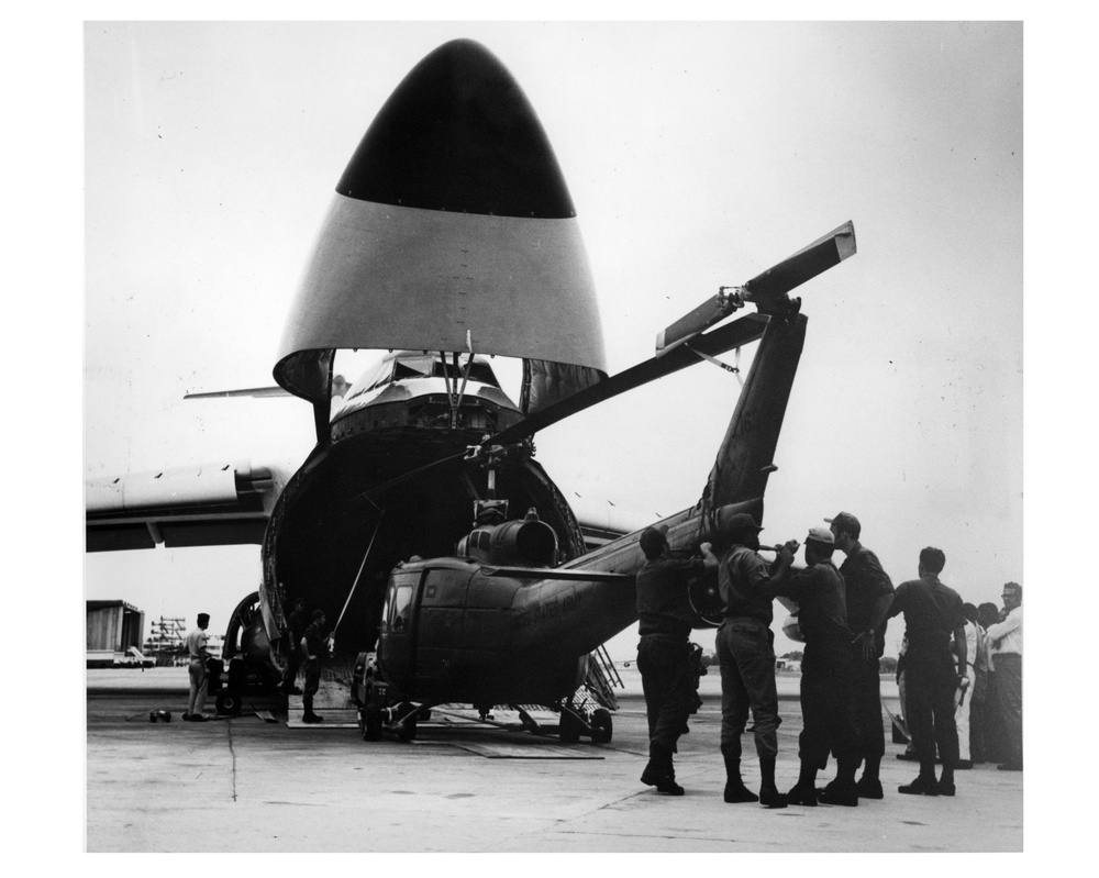 U.S. Army volunteers unload a UH-1 Bell