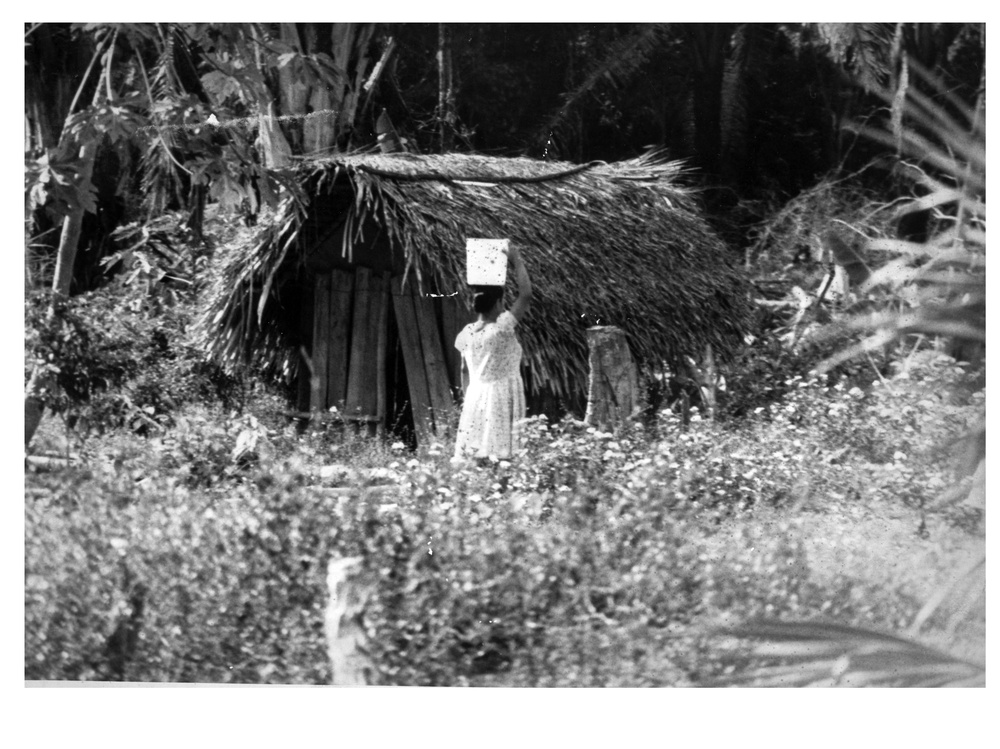 Woman carrying water to village in Belize