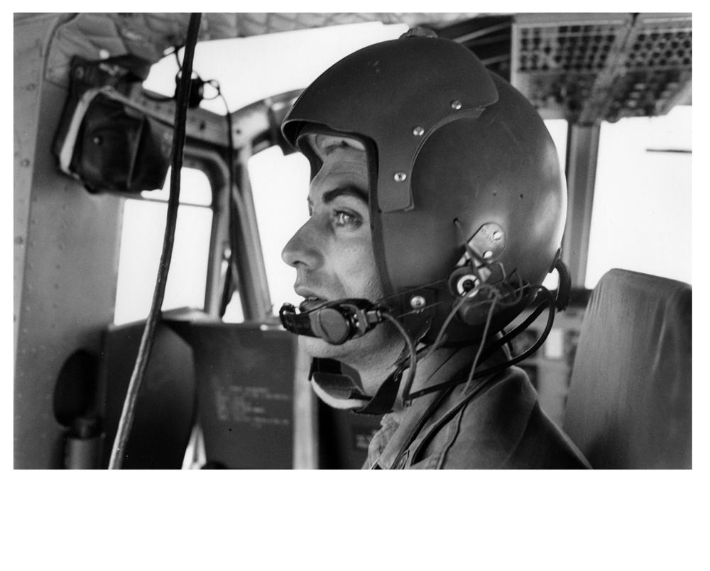 An American helicopter crew chief checks his aircraft prior to takeoff to the Delta on a relief flight, East Pakistan