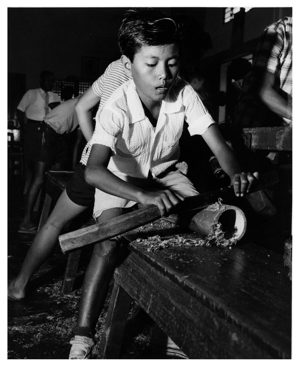Boy working bamboo with bolo -  The Philippines