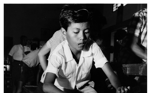 Boy working bamboo with bolo -  The Philippines