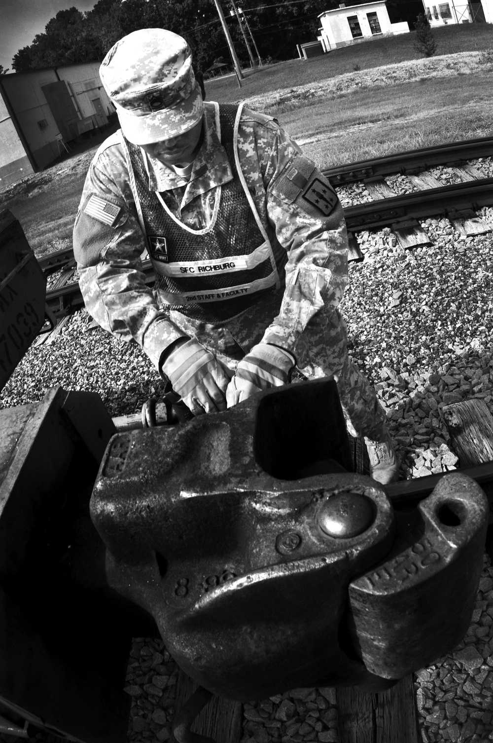 Railroader works on a coupler that connects railcars