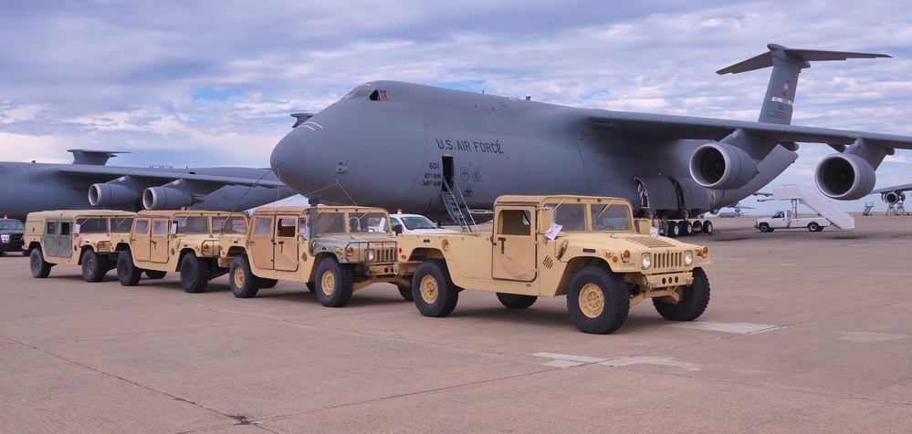 Soldiers stage HMMWVs for Loading aboard C-5