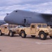Soldiers stage HMMWVs for Loading aboard C-5