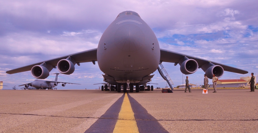 Airmen at Travis Air Force Base prepare to transport HMMWVs and Soldiers