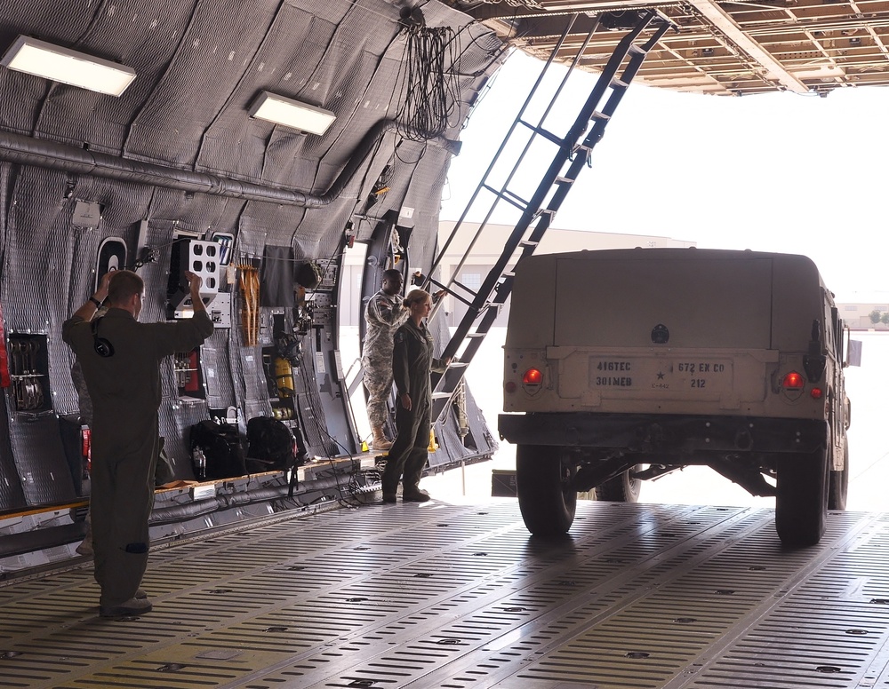 Airmen and Soldiers work side-by-side to load cargo